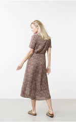 Load image into Gallery viewer, Printed long sleeve dress with knotted waist on model back view
