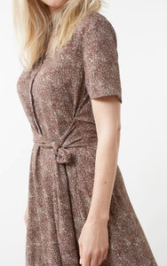 Printed long sleeve dress with knotted waist on model close up